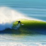 person surfing on sea waves during daytime