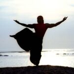 a person jumping on a beach